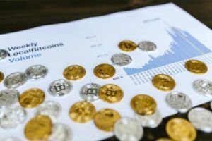 The Crypto Wars: A David vs. Goliath Battle for Your Digital Secrets Gold and silver Bitcoin coins placed on a graph showing LocalBitcoins trading volume analysis, symbolizing cryptocurrency market trends.